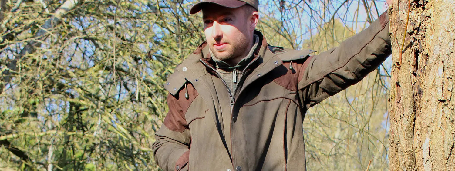 Man in brown jacket and maroon cap enjoying the shooting season outdoors in Hampshire Countryman.