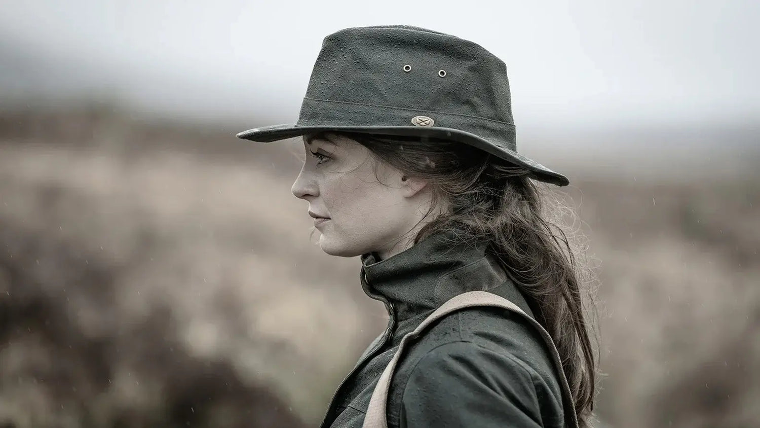 Woman in a dark hat and jacket showing how hats retain body heat during winter outings.