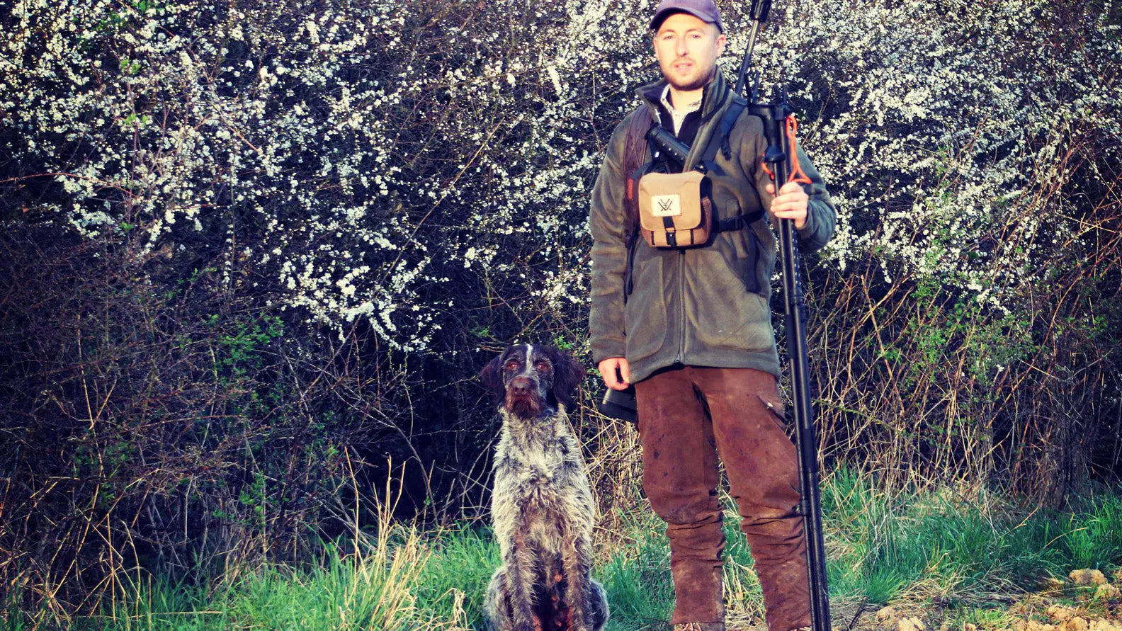 Hunter with dog in nature representing Hampshire Countryman brand ambassador for forest clothing