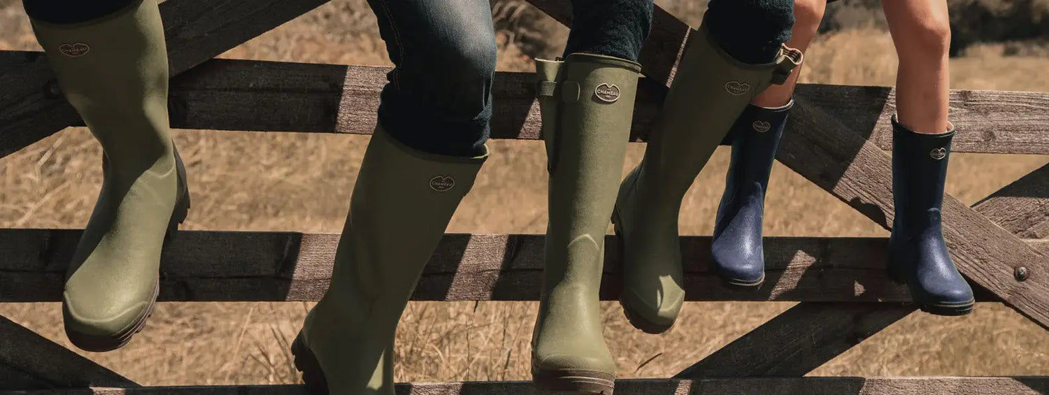 Colorful Wellington boots worn by people enjoying summertime slowly in the sun.