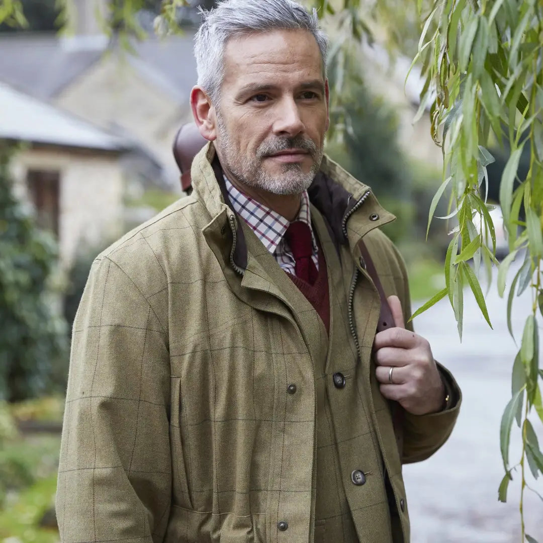 Middle-aged man with gray hair in Alan Paine Axford Waterproof Coat and plaid shirt