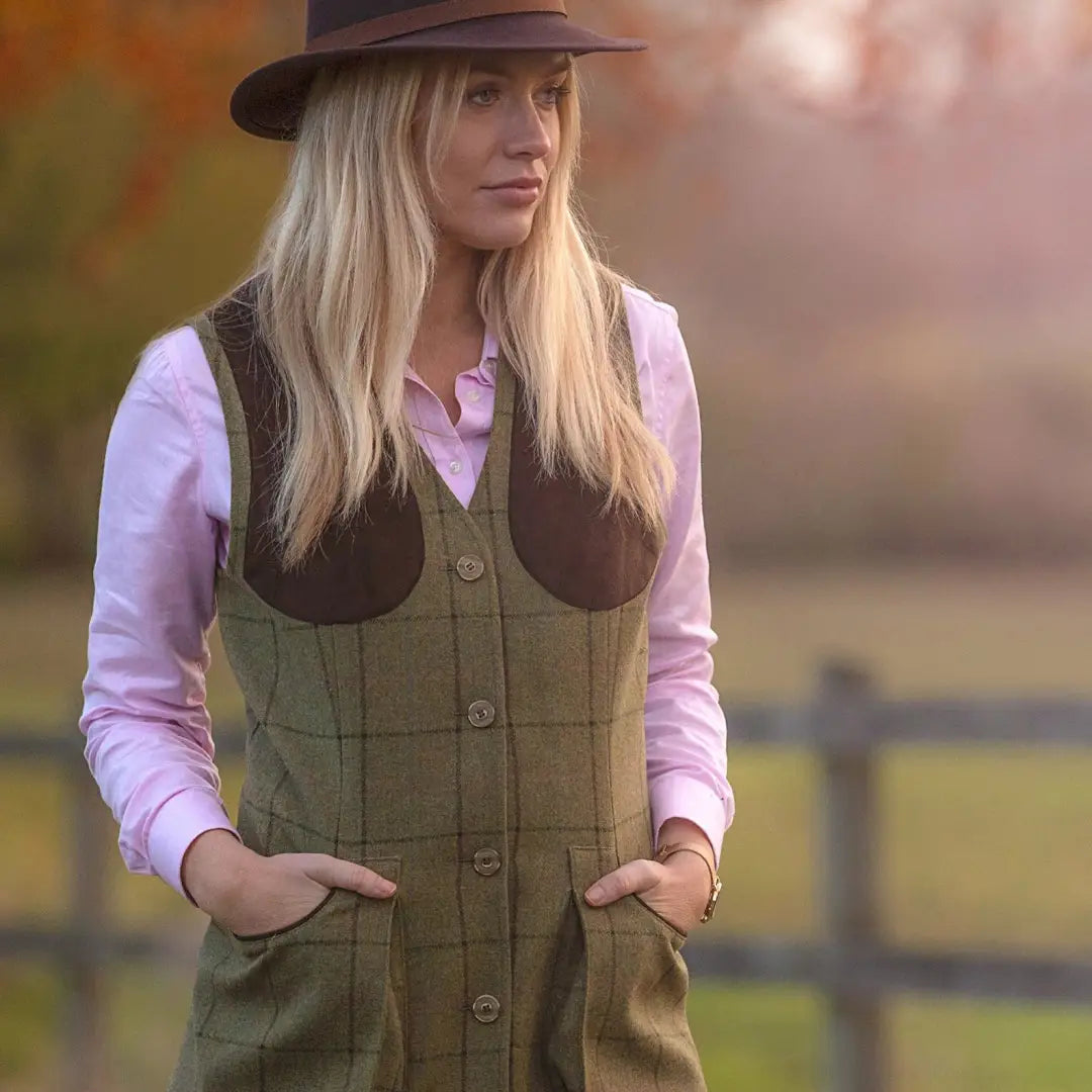 Woman in a wide-brimmed hat and Combrook Ladies Shooting Waistcoat in the countryside