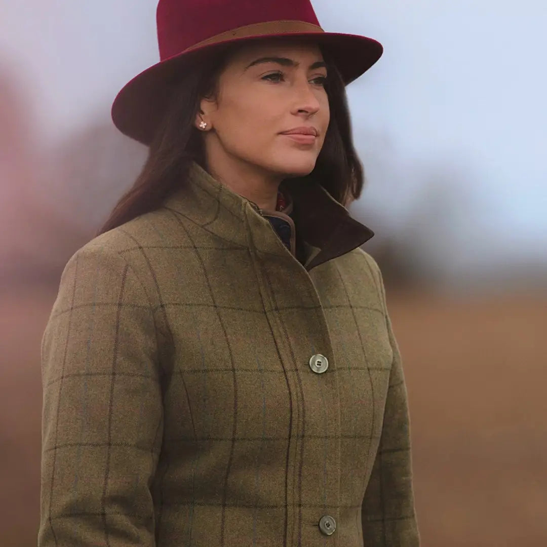 Woman in a red hat and olive green quilted field jacket with two flap pockets