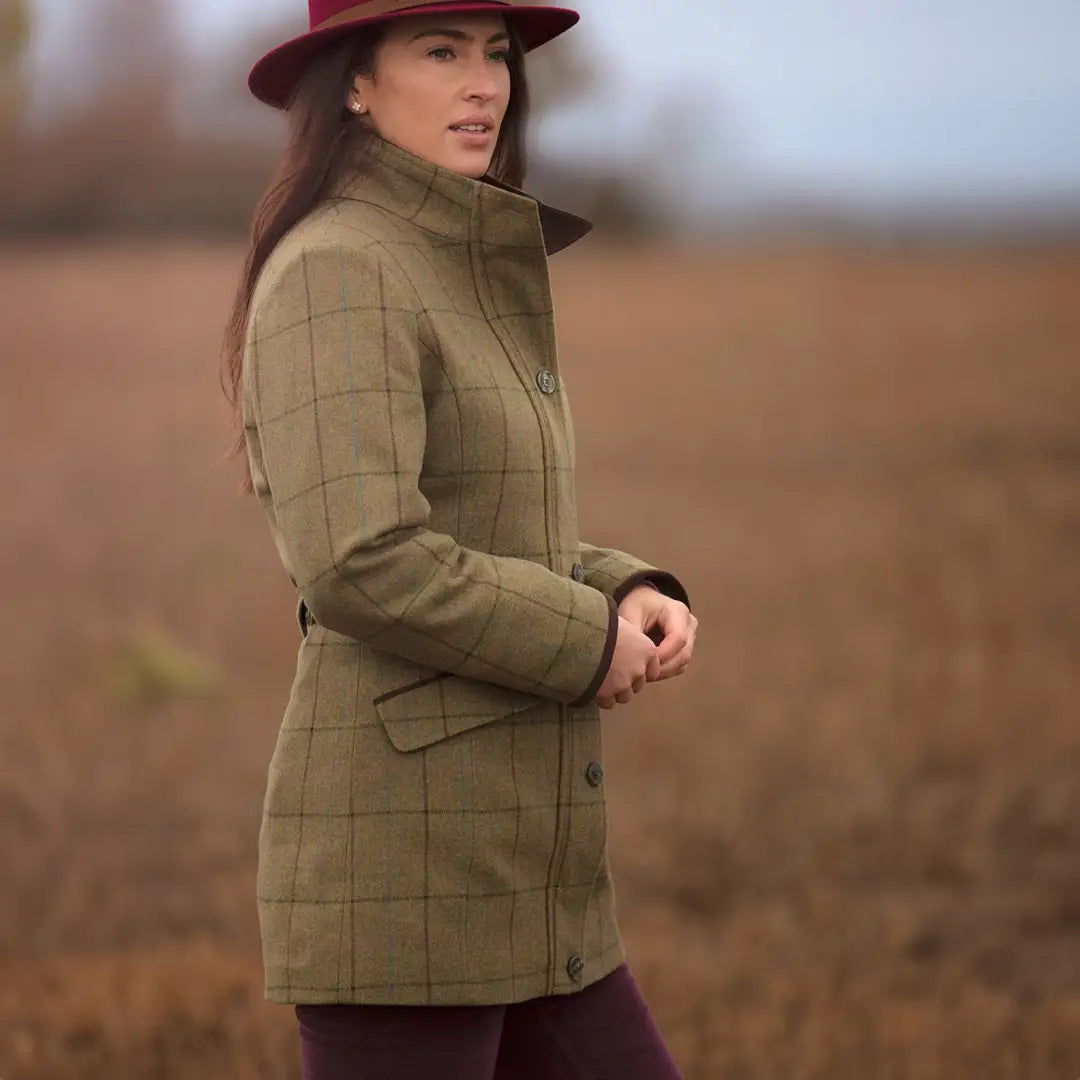 Woman in a red hat wearing Alan Paine Combrook field jacket with water repellent outer