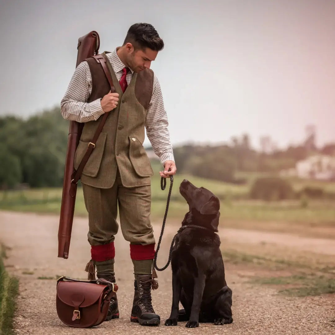 Man in traditional hunting gear with a black Labrador and Alan Paine Combrook waistcoat