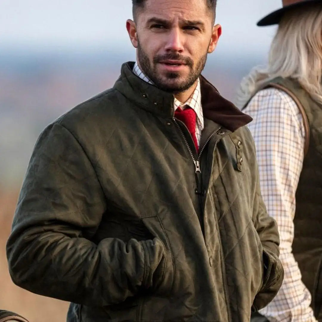 Man in a dark green Alan Paine luxurious quilted jacket and red tie