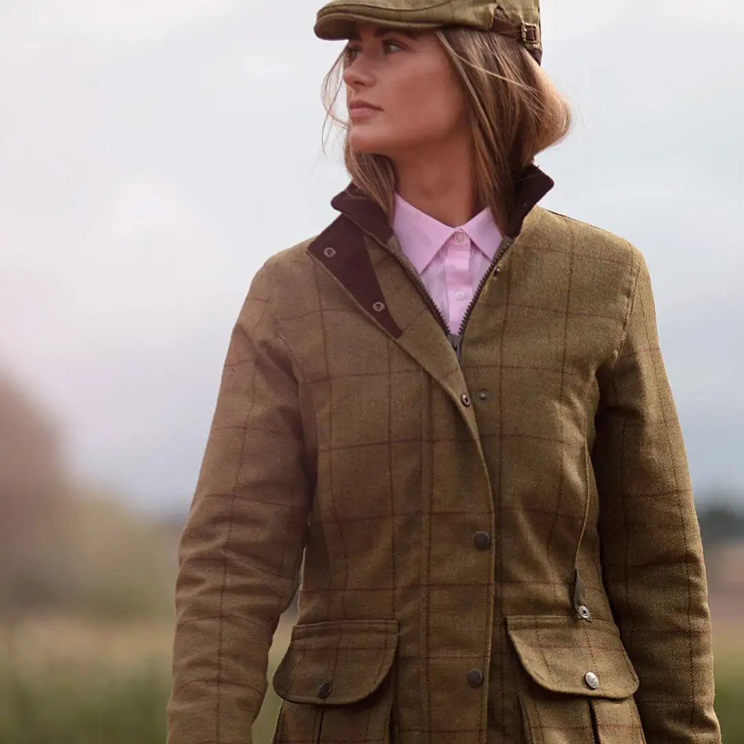 Woman in Alan Paine Rutland hunting jacket and cap enjoying the outdoors