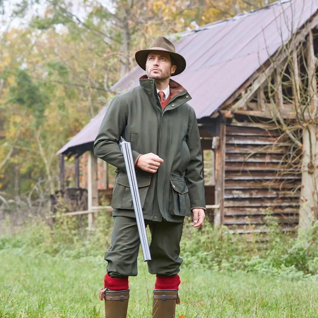 Man in hunting gear with a shotgun wearing Alan Paine Stancombe Waterproof Coat