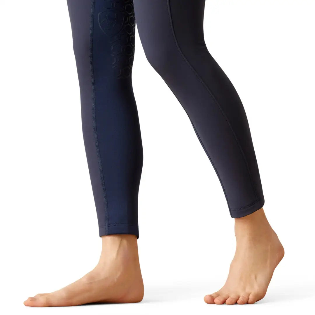 Pair of legs in dark blue Ariat Boreas Half Grip Tights, perfect for country clothing or outdoors