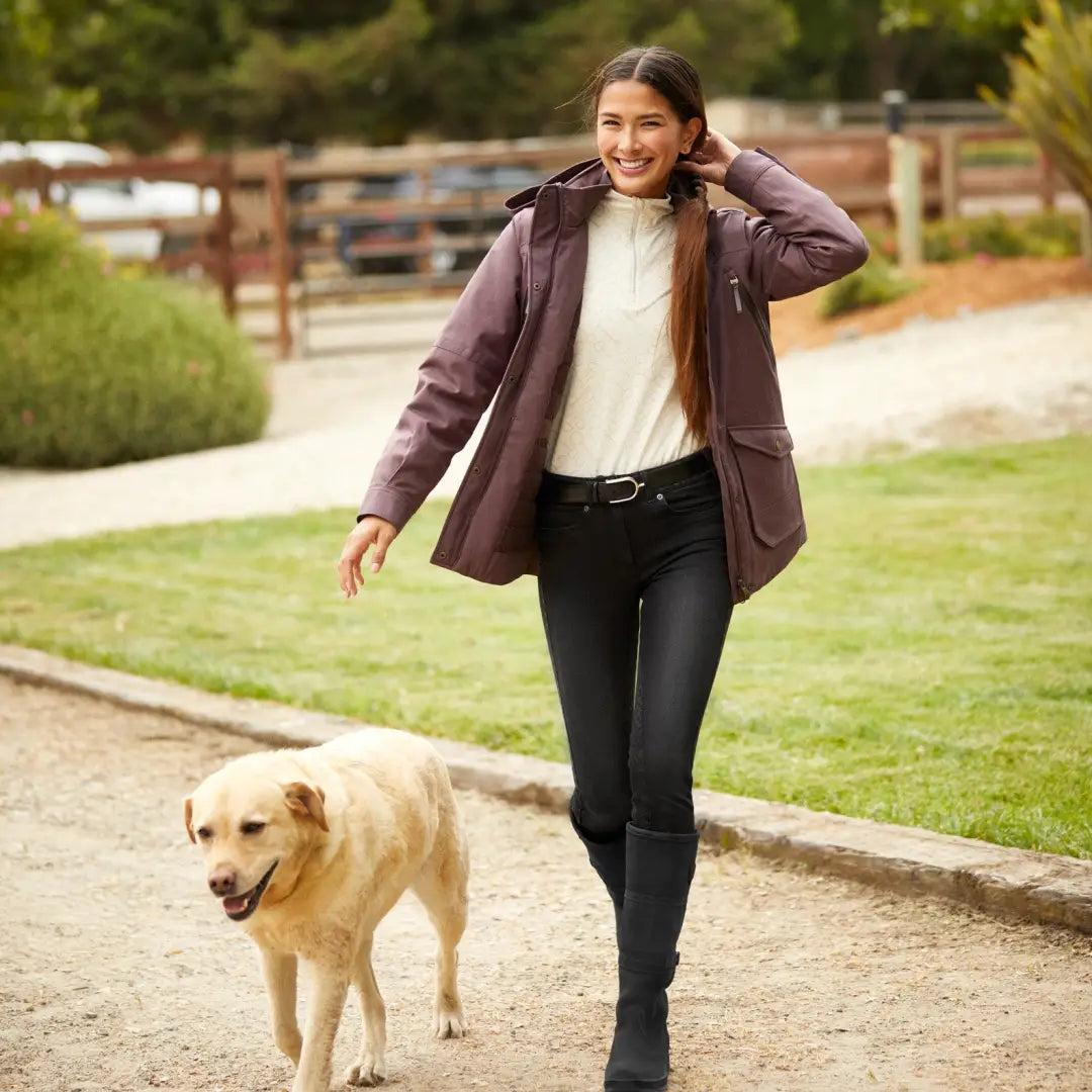 Woman walking a Golden Retriever in an Ariat Sterling Waterproof Insulated Parka