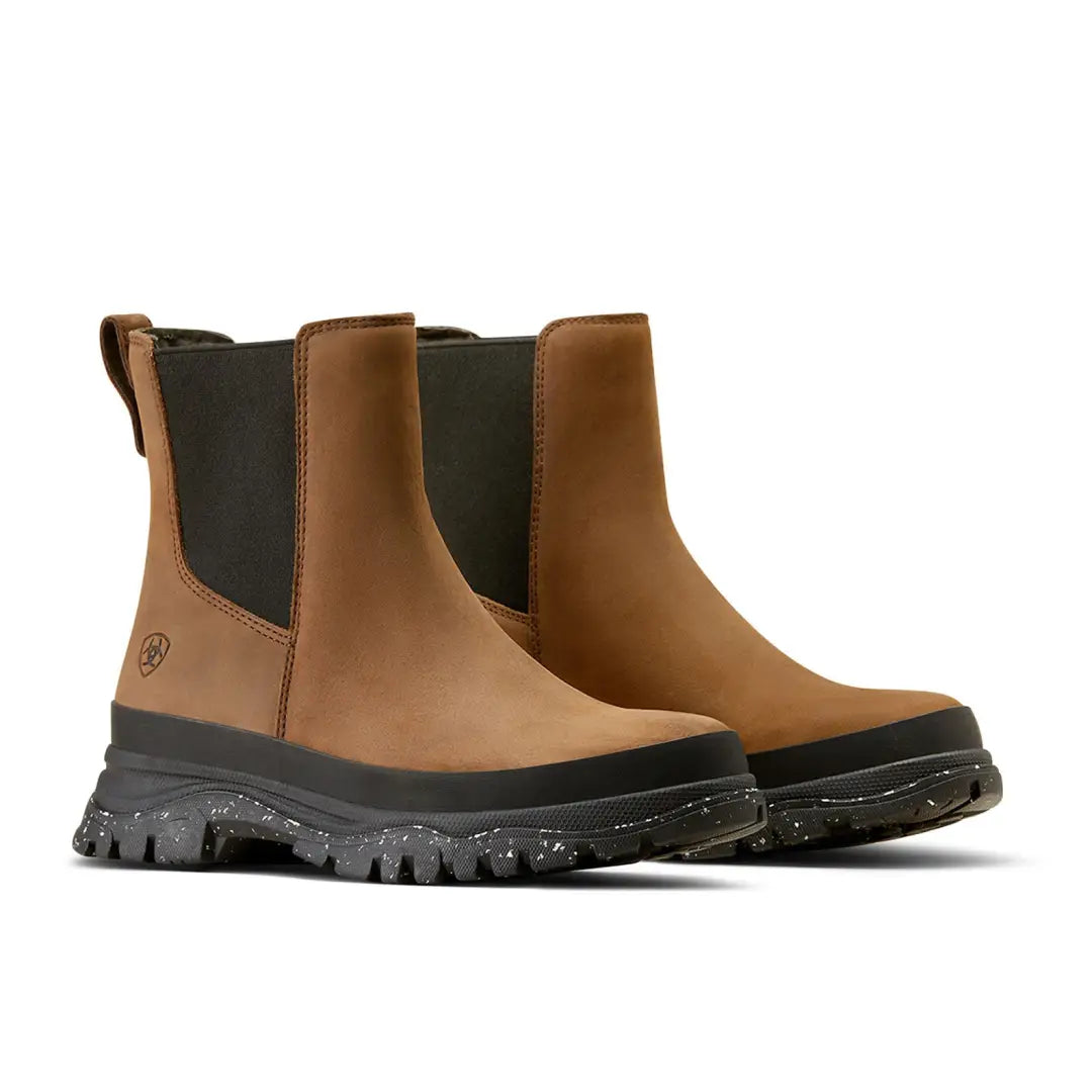 Tan leather Chelsea boots with black rubber soles, perfect for country clothing and outdoors