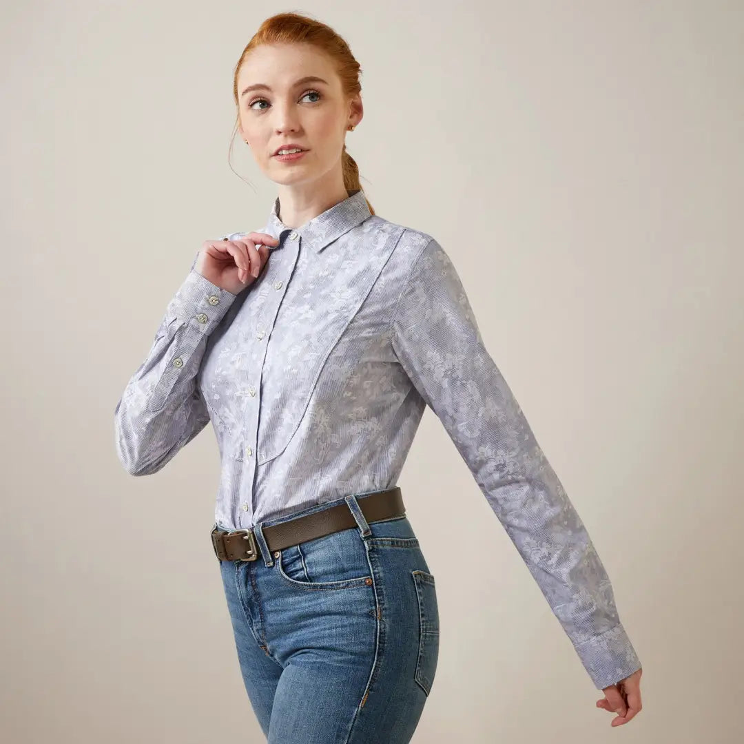 Woman in a light blue patterned blouse and jeans, perfect for country clothing and outdoors