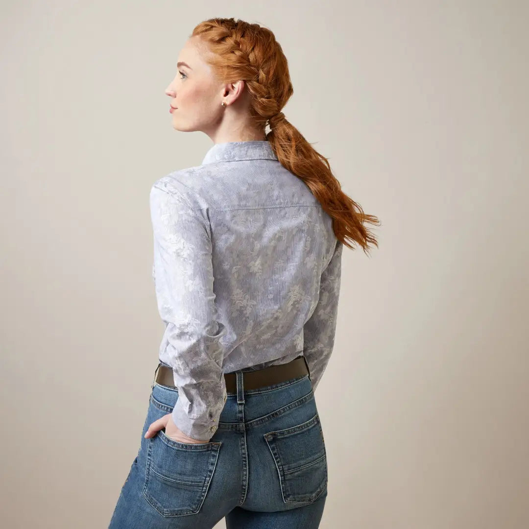 Woman with long red braids in a white blouse, perfect for country clothing or outdoors