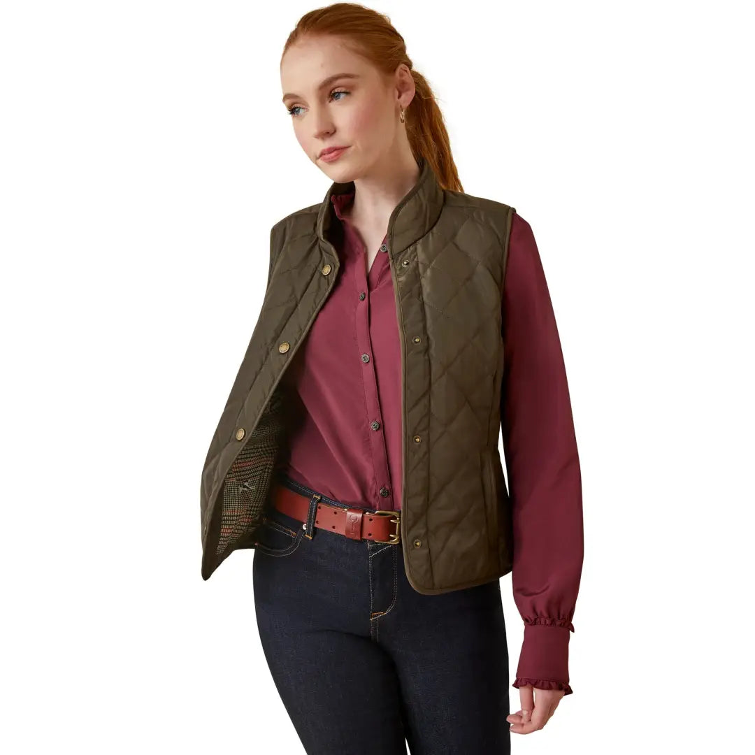 Olive green quilted Woodside Vest over a burgundy shirt, stylish and eco-friendly design