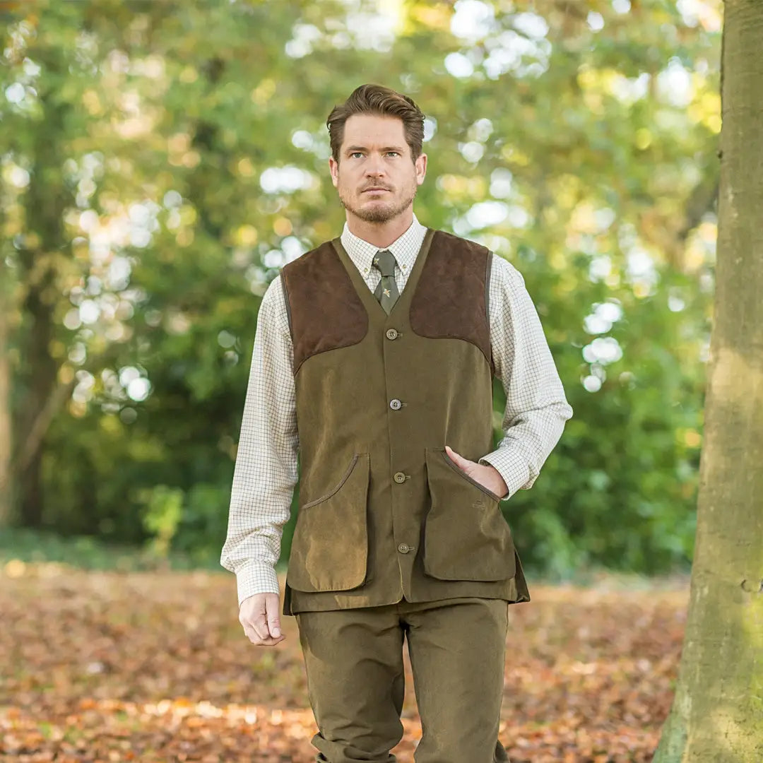 Man in a Baleno Dolman Traditional Gilet with quilted shoulders over a dress shirt and tie