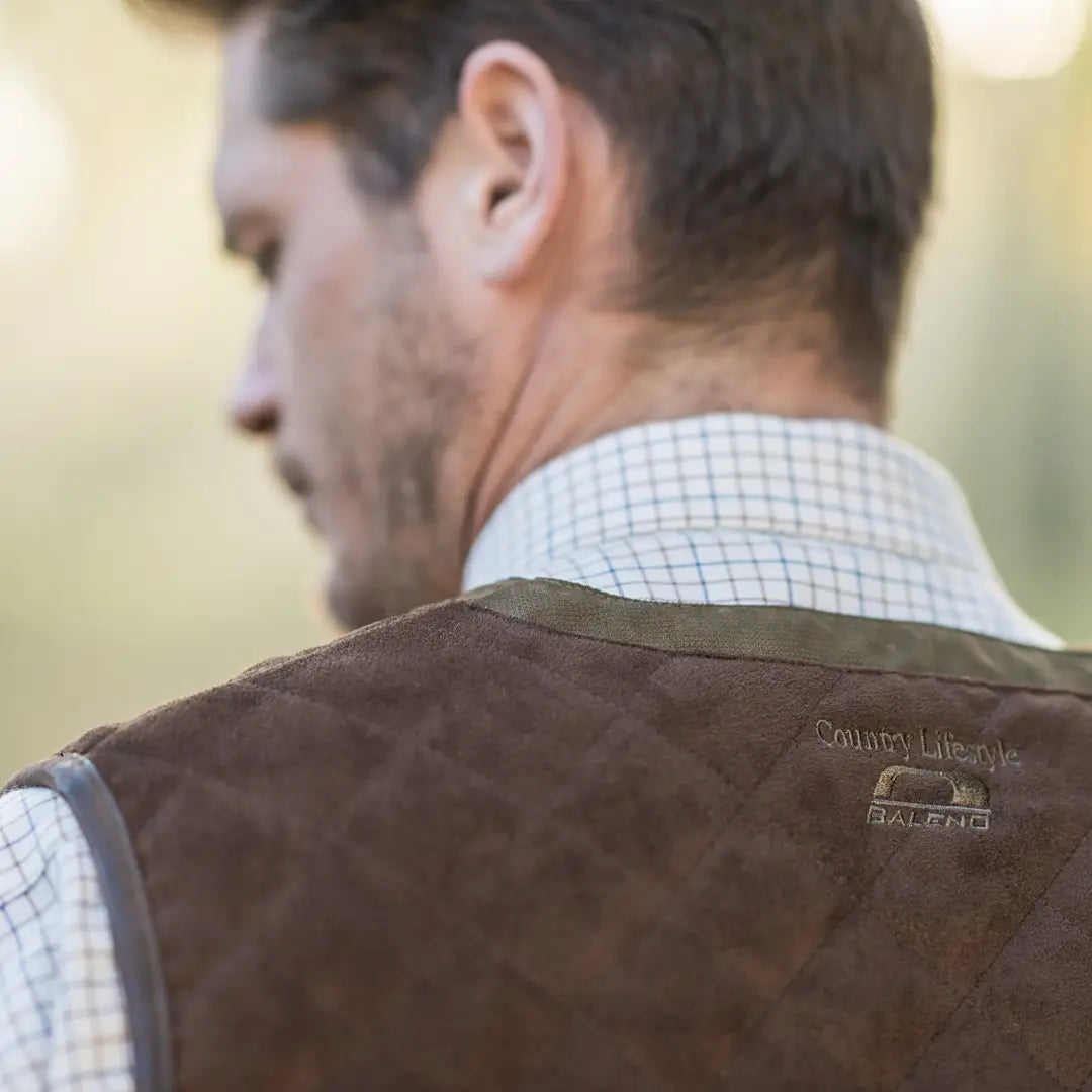 Brown leather vest over white checkered shirt, featuring quilted shoulders for Baleno Dolman