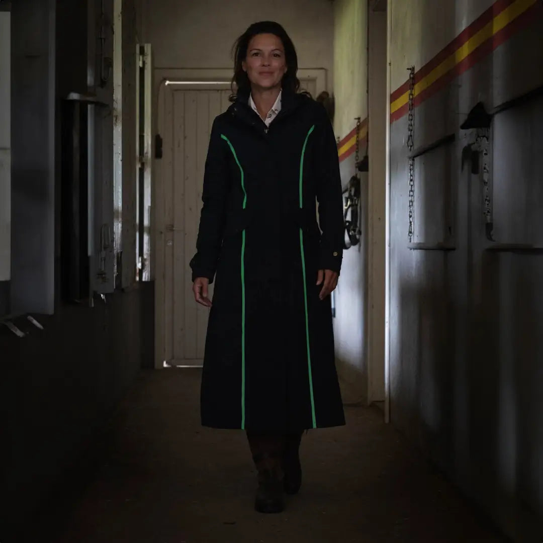 Woman in Baleno Kensington Safe jacket with green trim in a cozy hallway