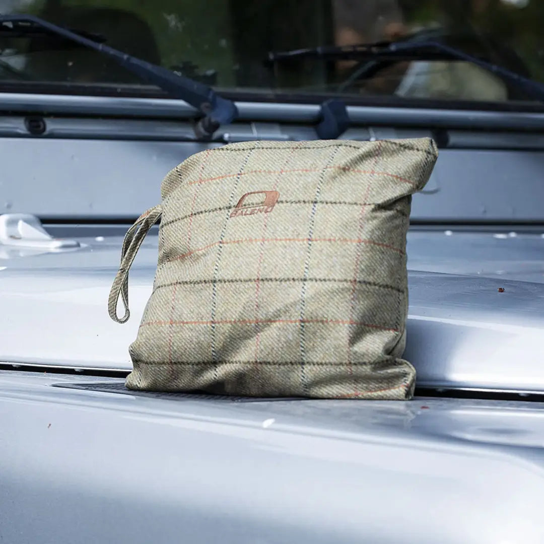 Plaid fabric bag on car roof with Baleno Moorland Mens Waterproof Jacket