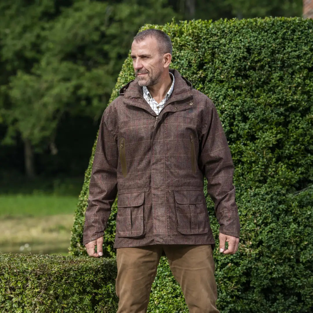 Middle-aged man in brown leather jacket showcasing the Baleno Moorland Mens Waterproof Jacket