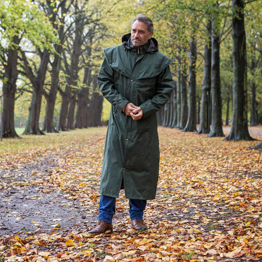 Long green Baleno Newbury Mens Full Length Coat worn amidst autumn leaves