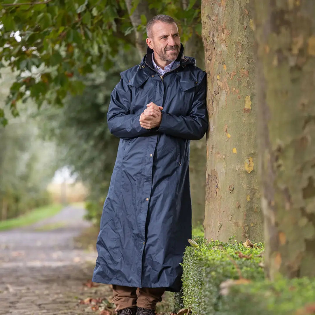 Middle-aged man in a Baleno Newbury men’s jacket by a tree on a rainy day