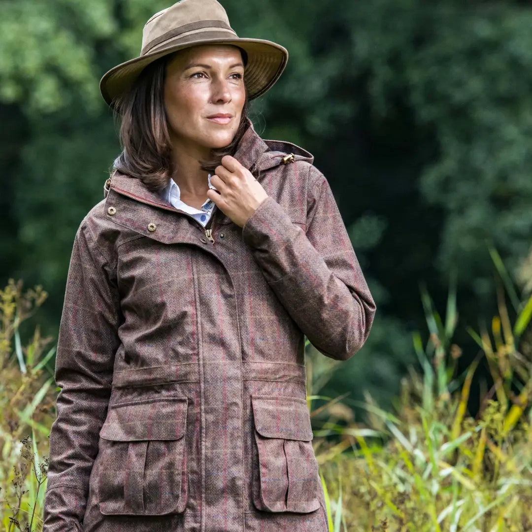 Woman in a brown jacket and tan hat wearing the Baleno Pembroke Ladies Waterproof