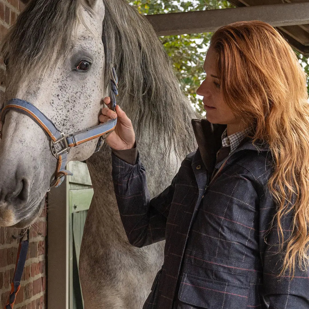 White horse with a long mane being petted in a Baleno Pembroke Ladies Waterproof Jacket