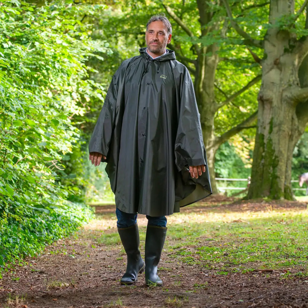 Person in a Baleno Tornado Poncho walking a forest path, perfect for favourite outdoor activities