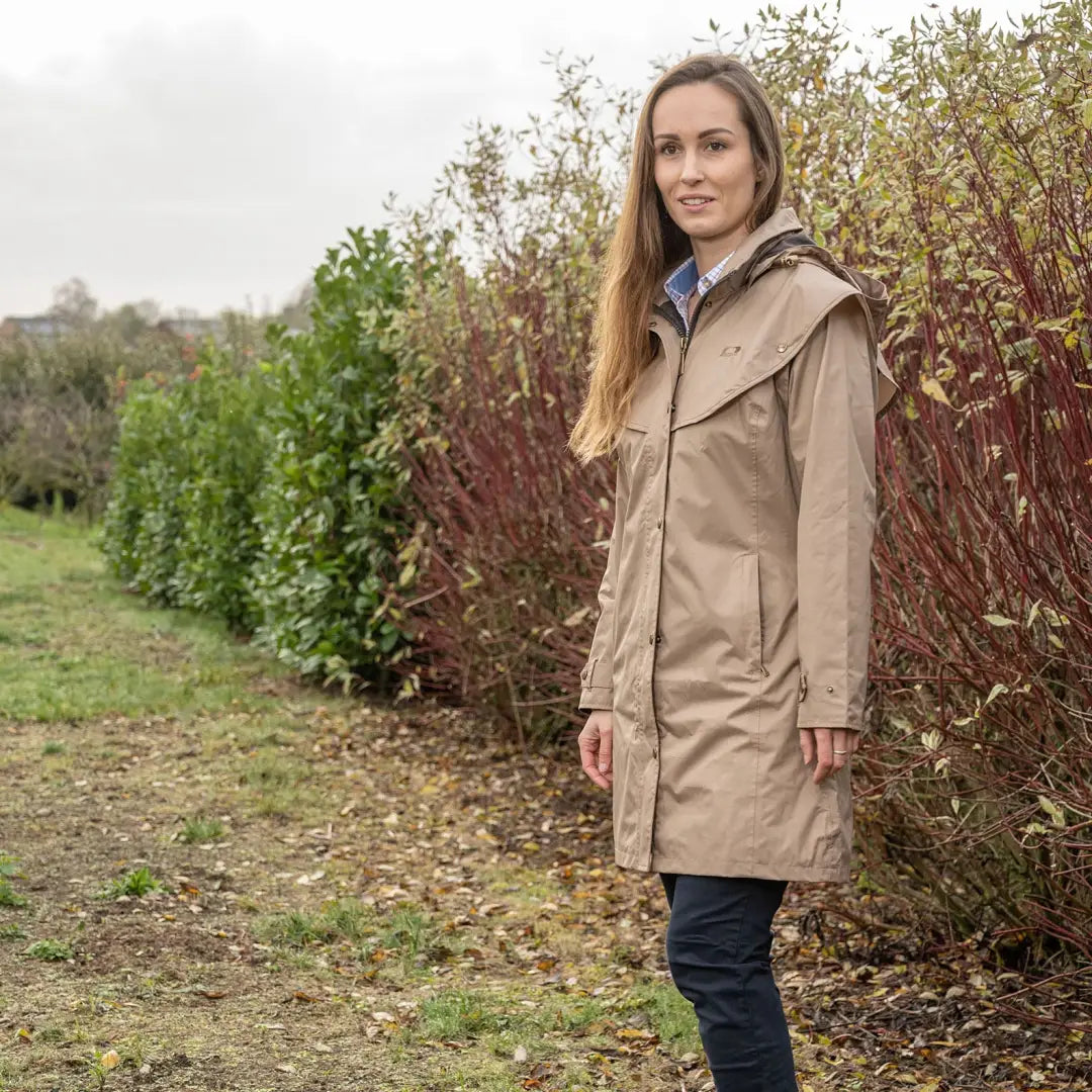 Woman in a beige trench coat outdoors showcasing the Baleno Worcester Ladies Length Coat