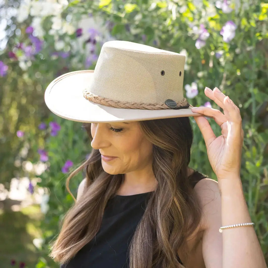 Beige wide-brimmed straw hat with braided band for country clothing and outdoor adventures