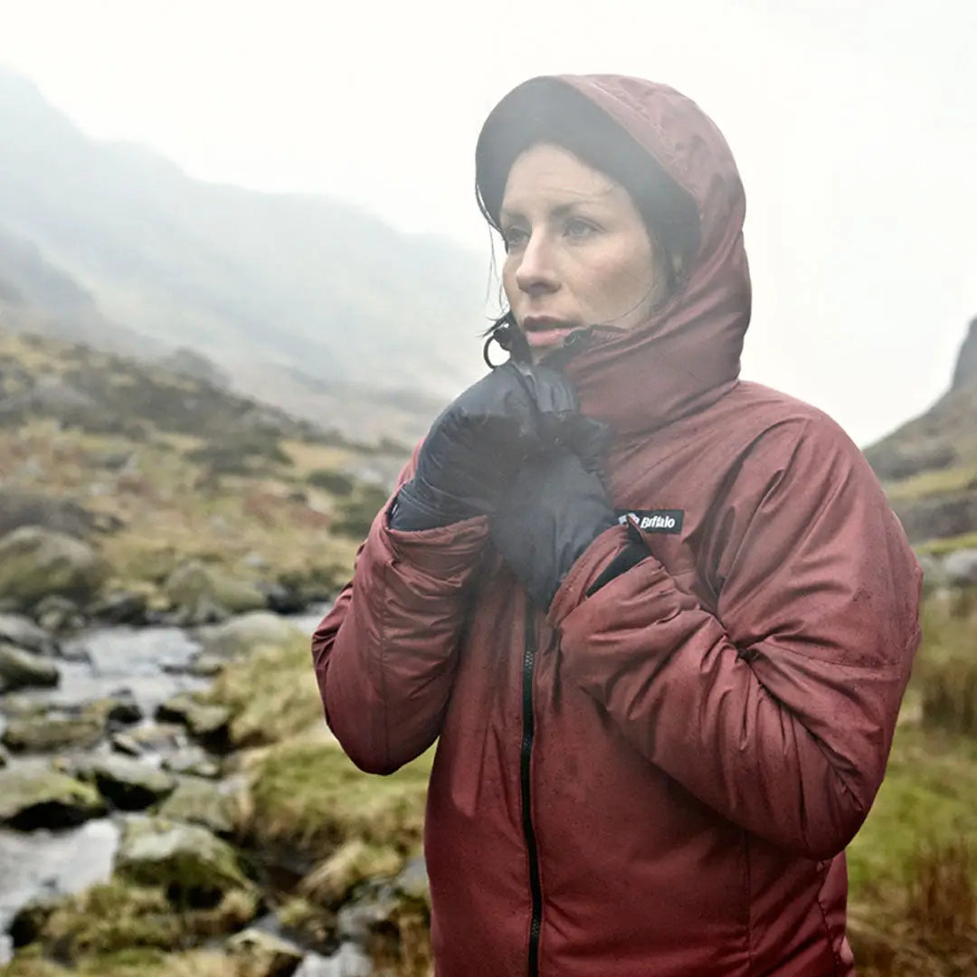 Person in a red Buffalo Women’s Alpine Jacket enjoying the misty outdoors for country clothing