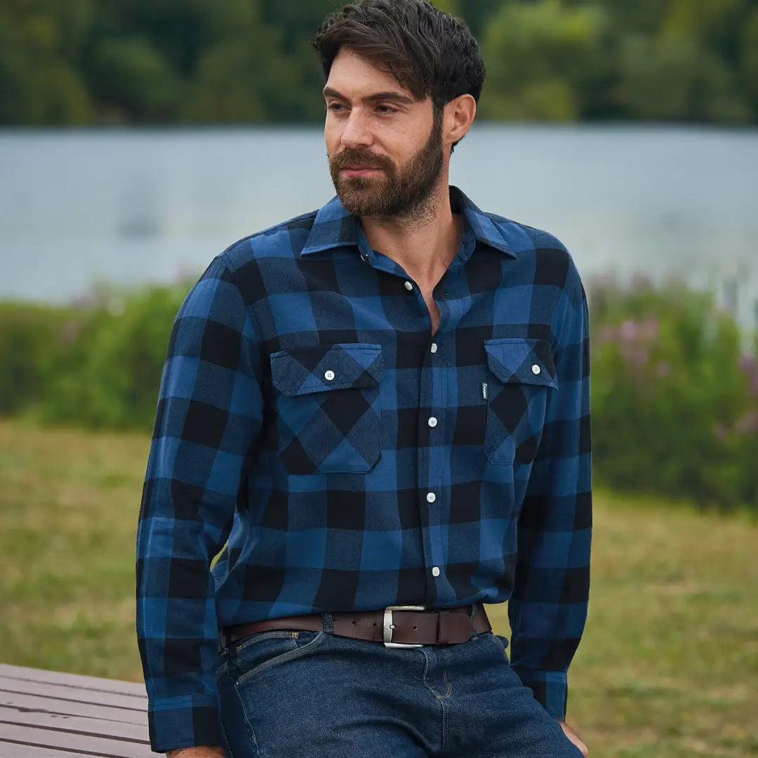 Man in a blue and black plaid flannel shirt from the Champion Arran Long Sleeve Shirt