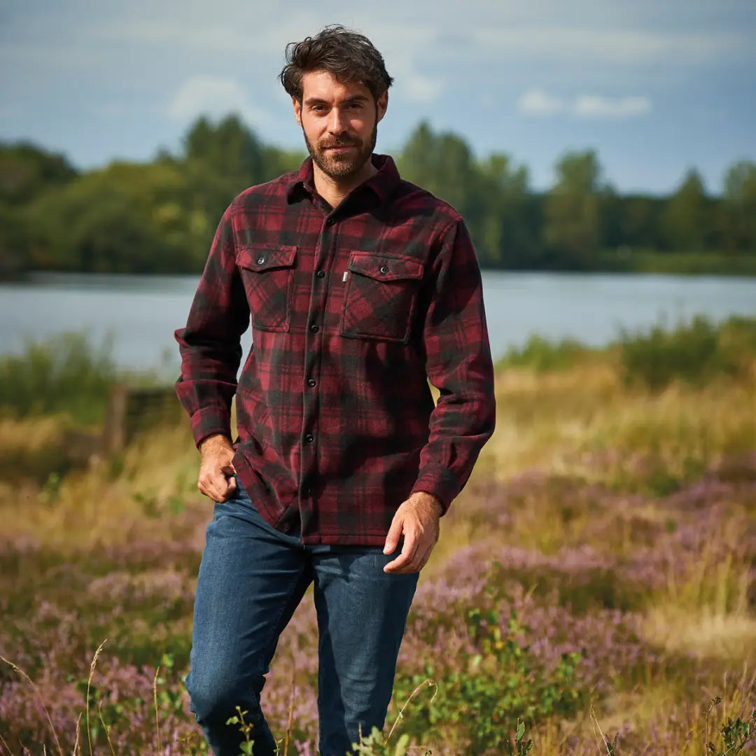 Man rocking a Champion Eskdale fleece shirt in red and black plaid with jeans