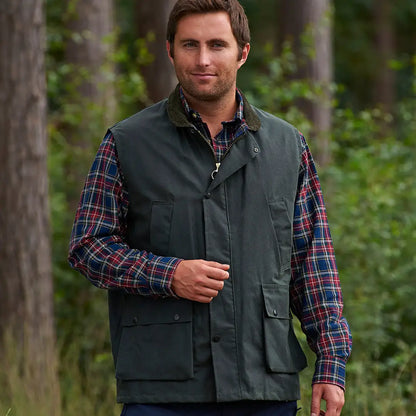 Green Champion Lanark Wax Bodywarmer over a plaid shirt for stylish outdoor vibes