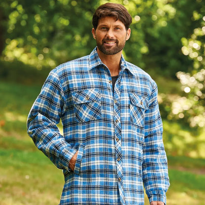 Man with a beard in a Champion Pennine Padded Sherpa shirt, blue and white plaid