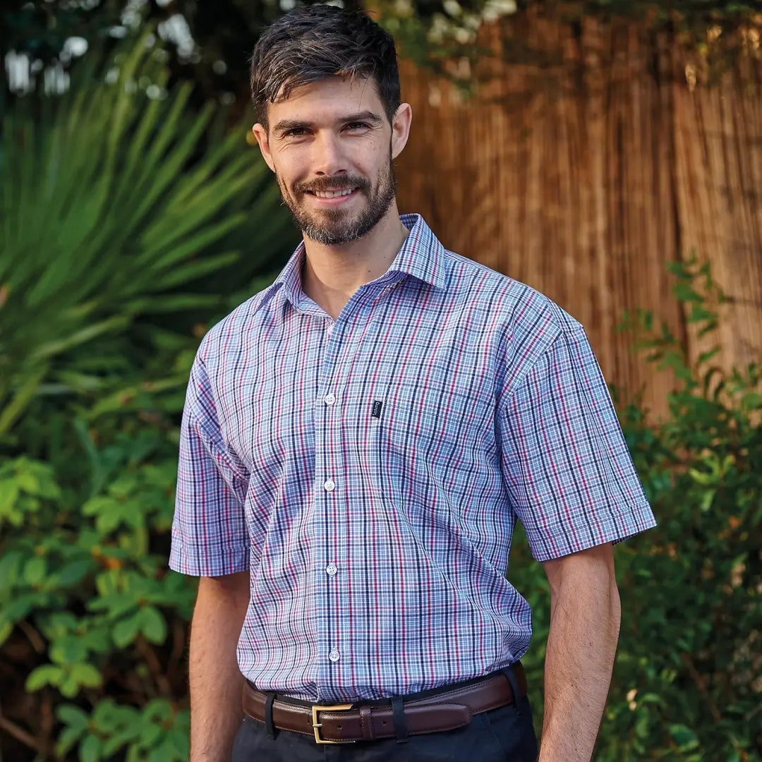 Man in a plaid Champion Poole short sleeved shirt showcasing casual style