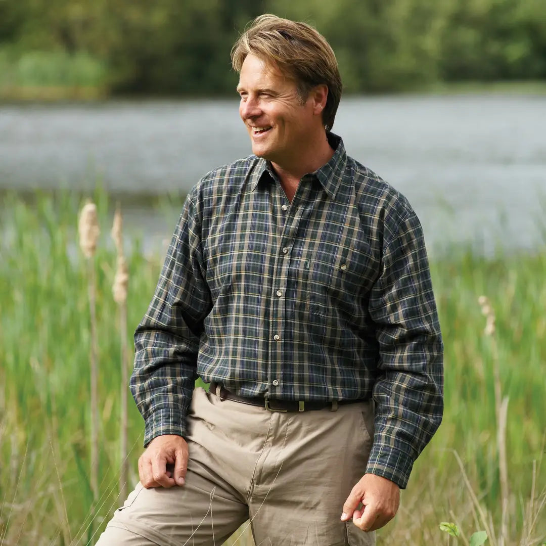 Man in a plaid Champion Sherborne fleece lined shirt and khaki pants outdoors