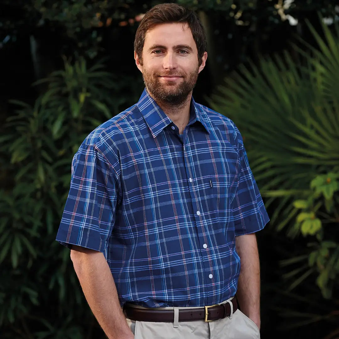 Man in a blue plaid Champion Whitby short sleeved shirt, stylish and comfy