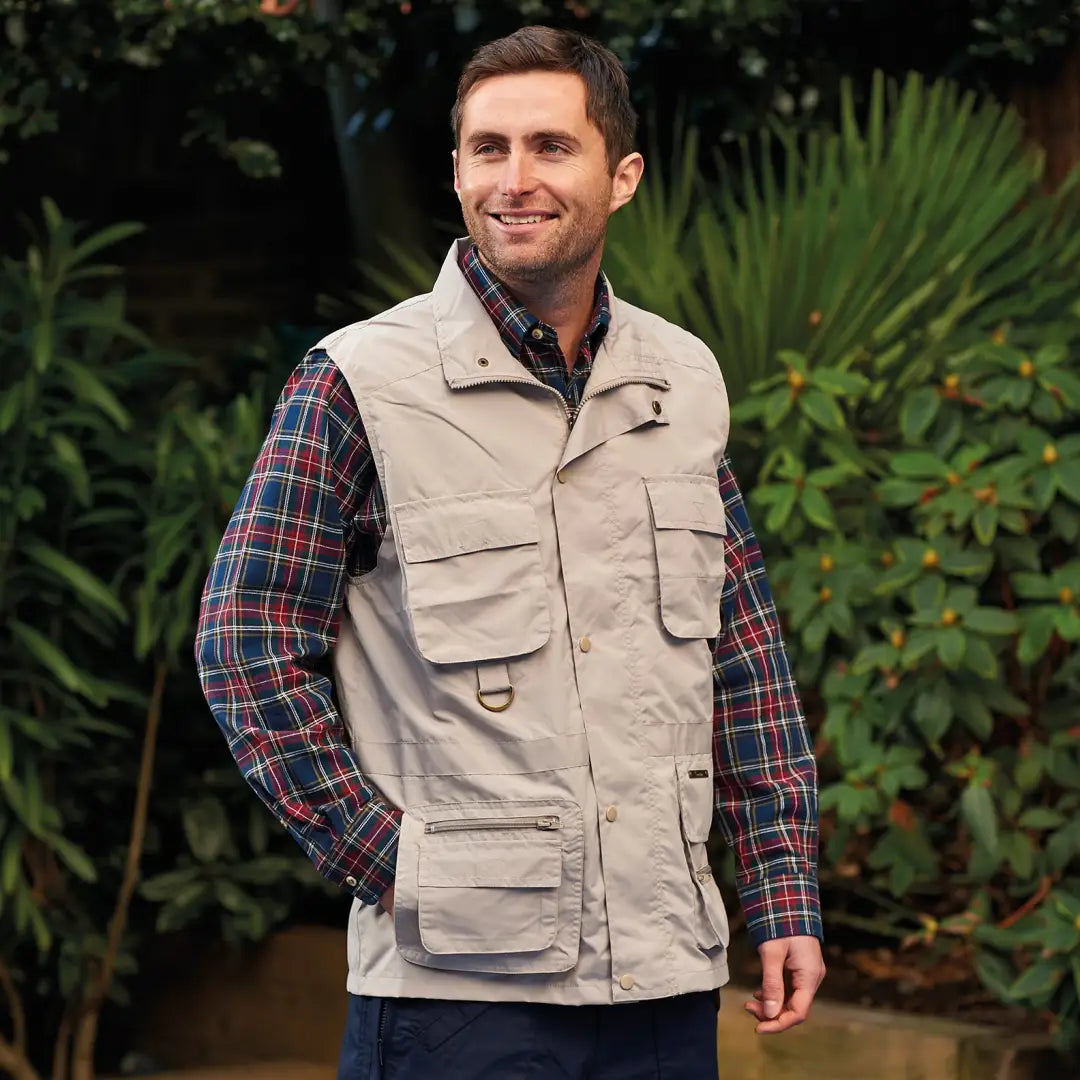 Beige multi-pocketed Champion Windermere Gilet over a stylish plaid shirt