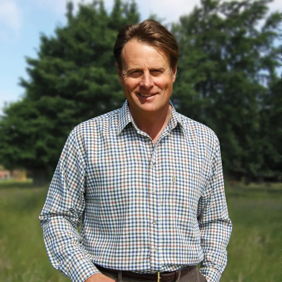 Middle-aged man with brown hair modeling Champion York Shirt in a checkered pattern