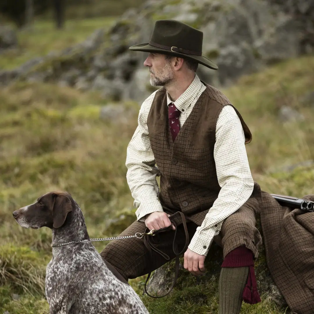 Man in traditional hunting attire with a dog wearing Deerhunter Adventurer Felt Crushable Hat