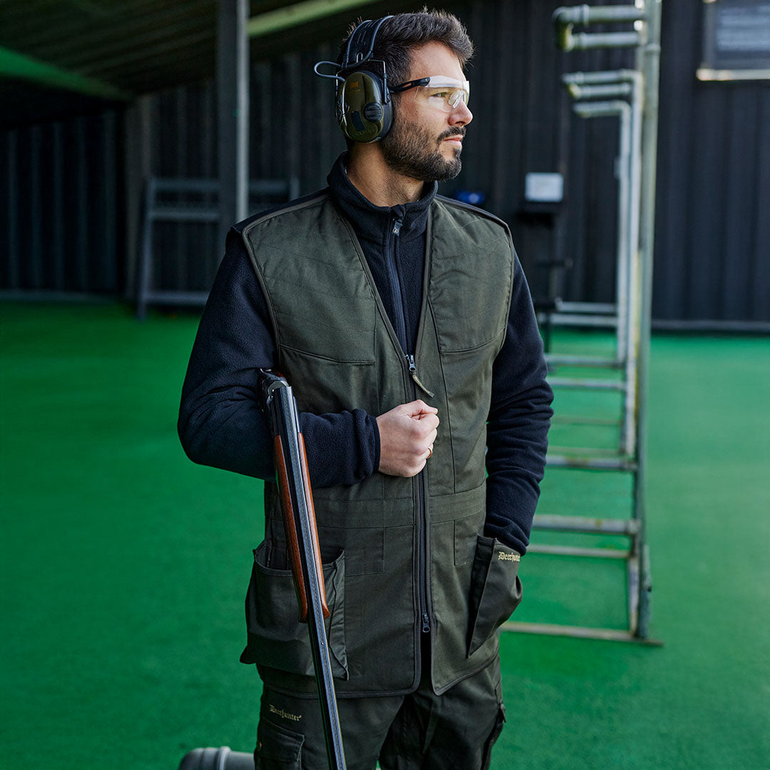 Man in shooting gear with a shotgun wearing the Atlas Shooting Waistcoat