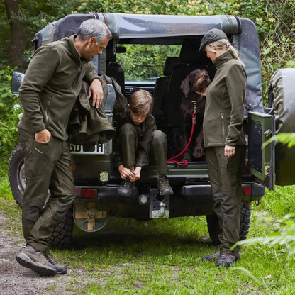 People exploring a Military-style off-road vehicle near a Deerhunter Chasse Fleece Jacket