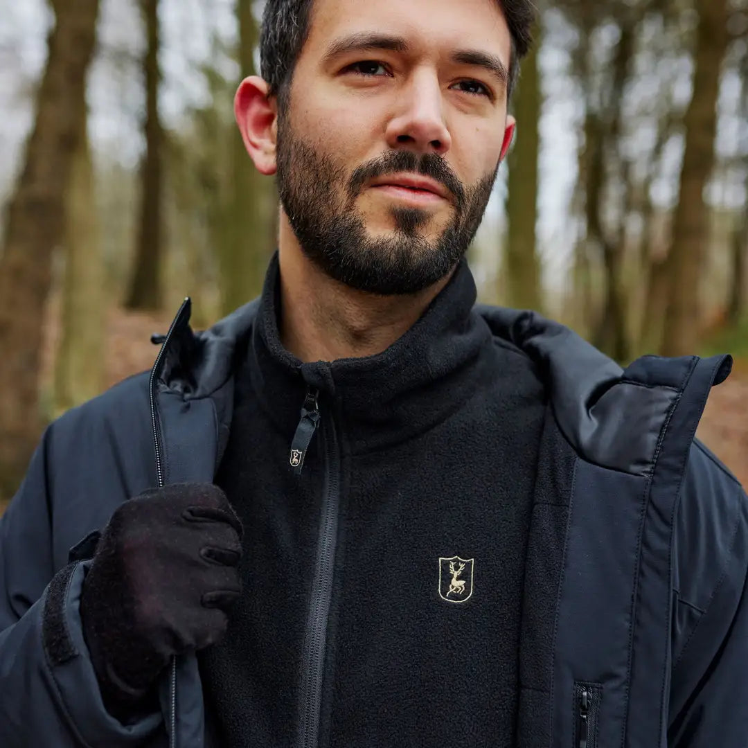 Man with a beard in a forest wearing a Deerhunter Denver Winter Jacket