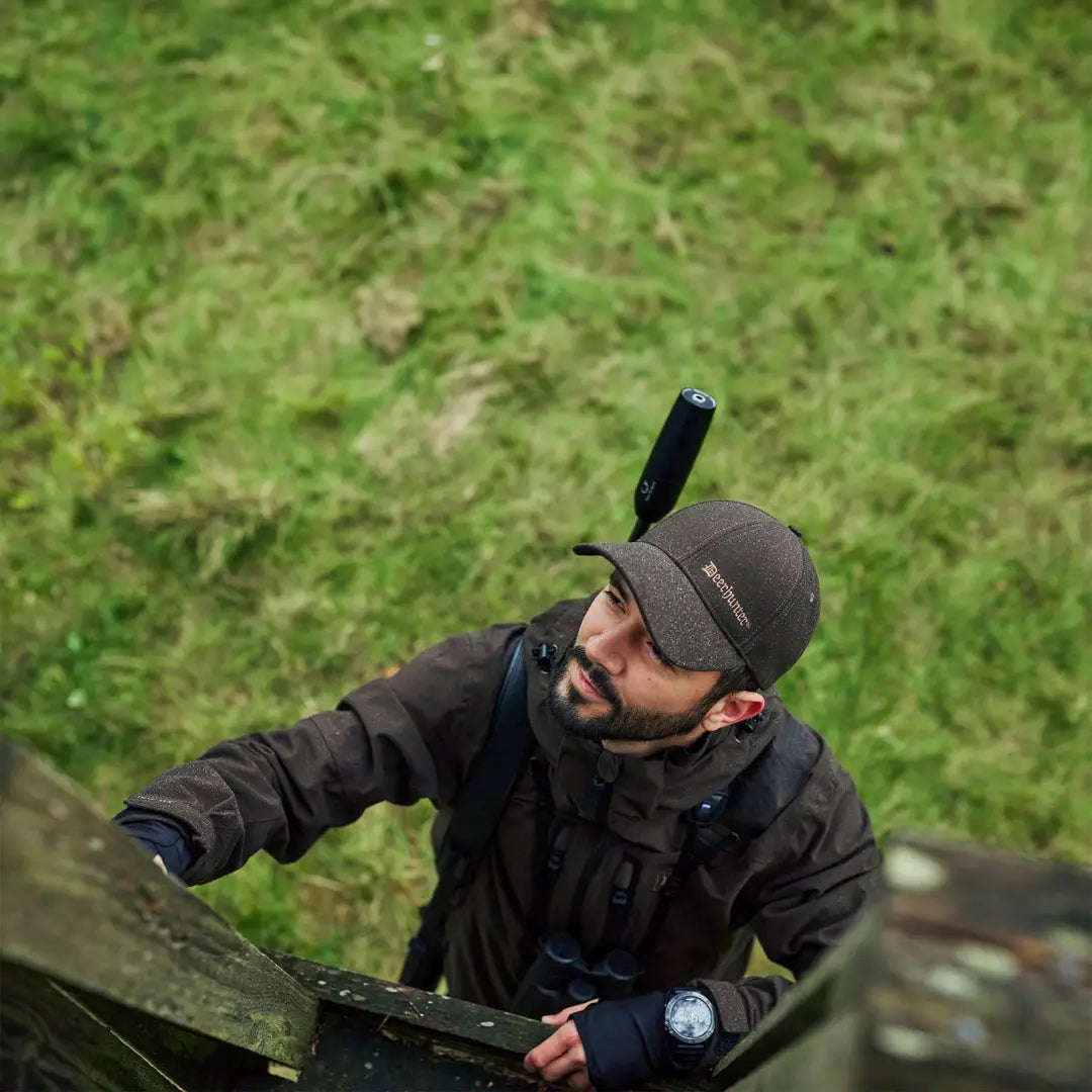 Man in dark clothing wearing a cap, showcasing the Deerhunter Game Pro Light Jacket