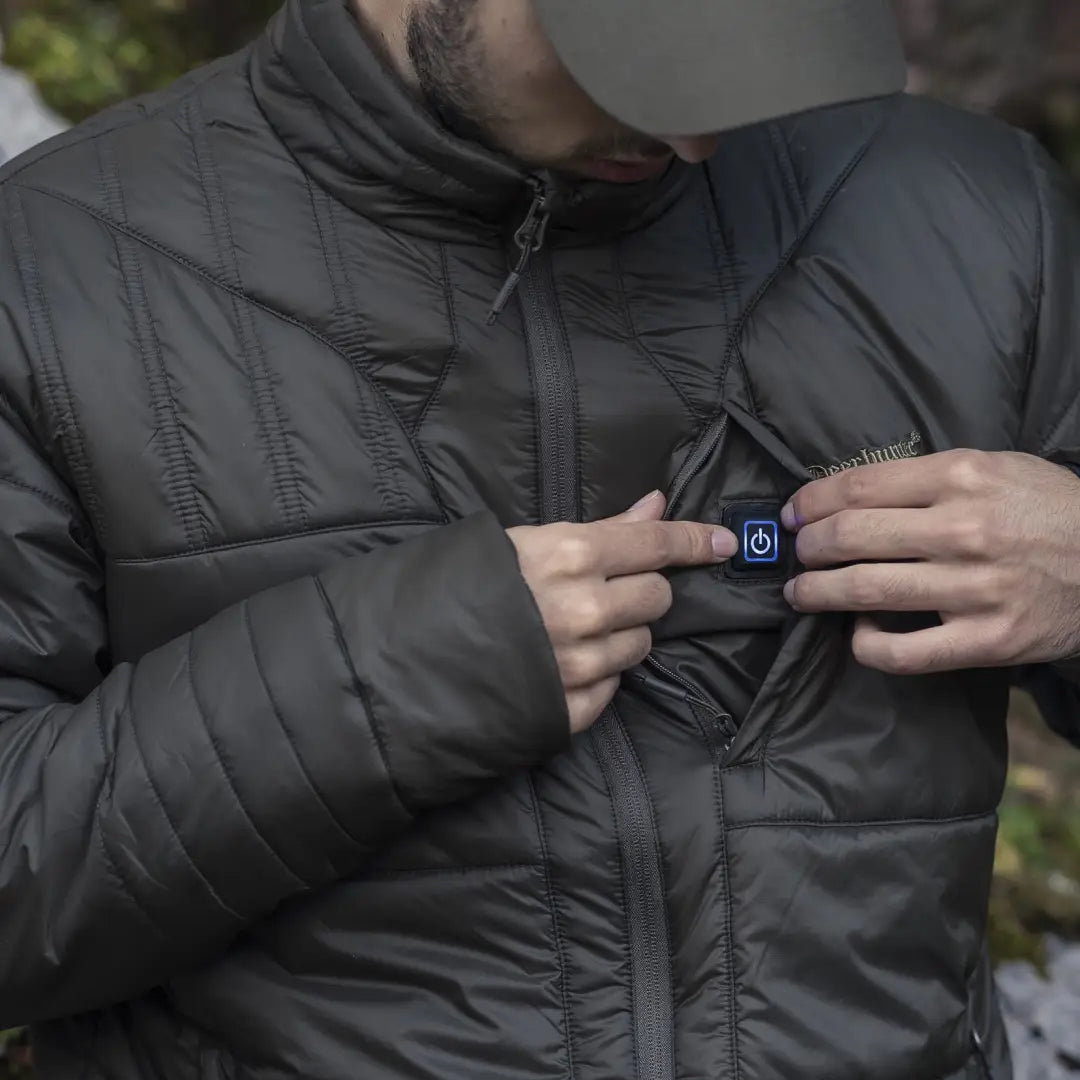 Hands in a puffy black jacket show a Smartwatch with Deerhunter Heat Jacket vibes