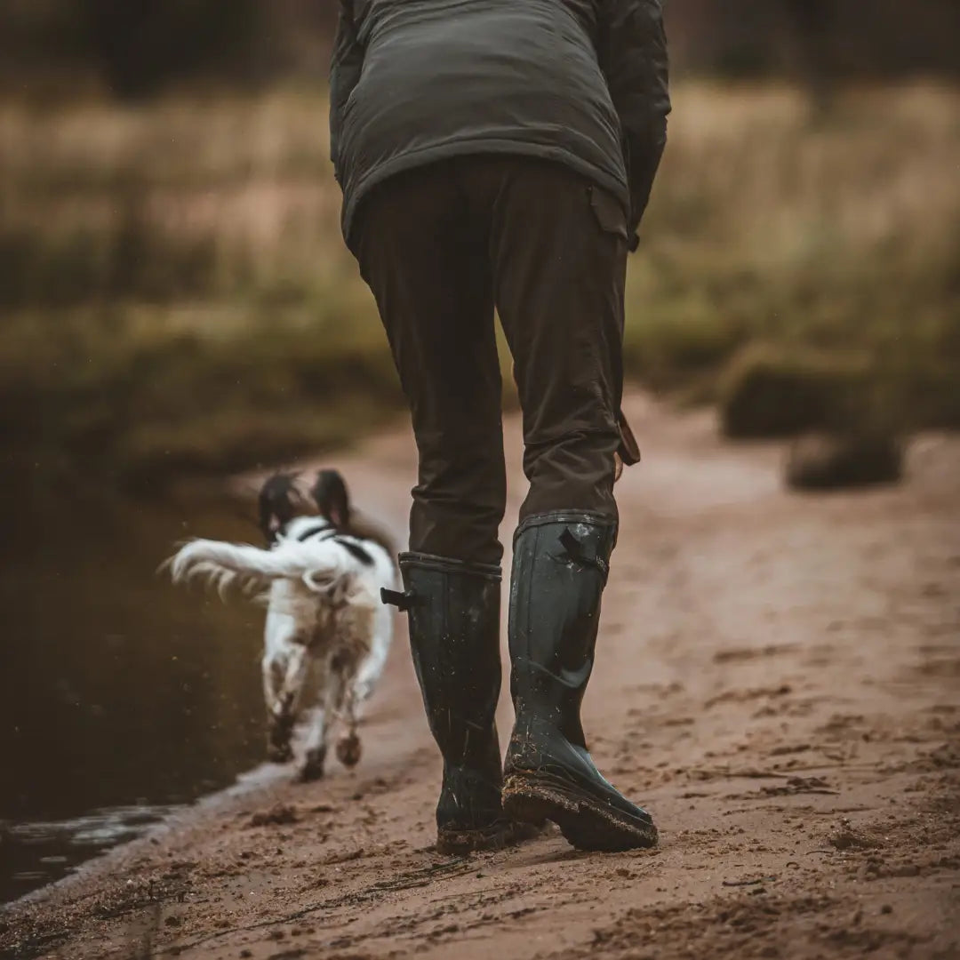 Person in Deerhunter Lady Ann Full Stretch Trousers walking a small dog on a muddy path