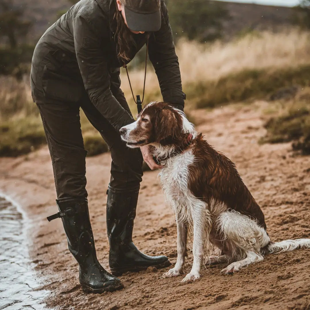 Brown and white dog by person in boots wearing Deerhunter Lady Ann Full Stretch Trousers