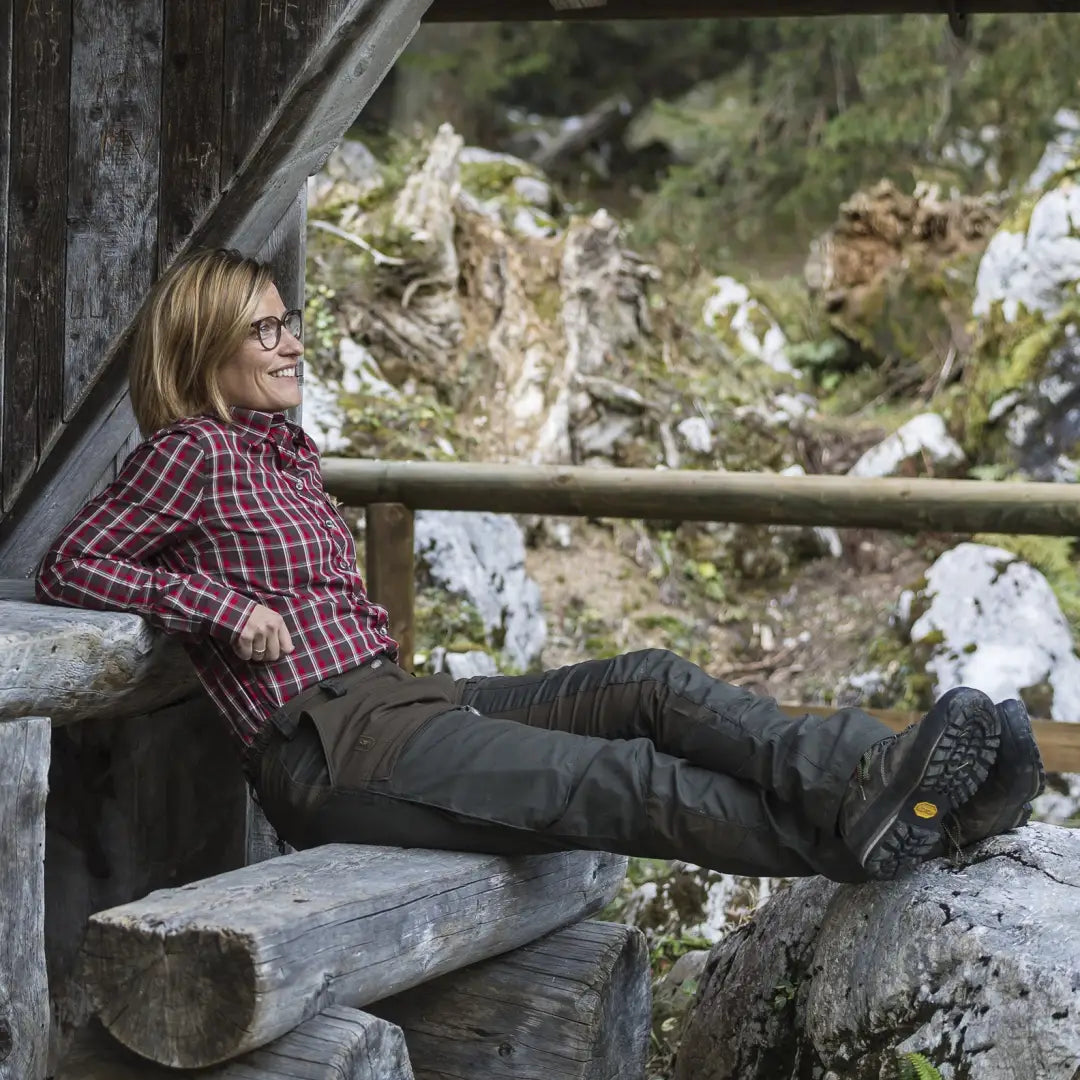 Woman in Lady Ann Trousers relaxing on a wooden bench outdoors