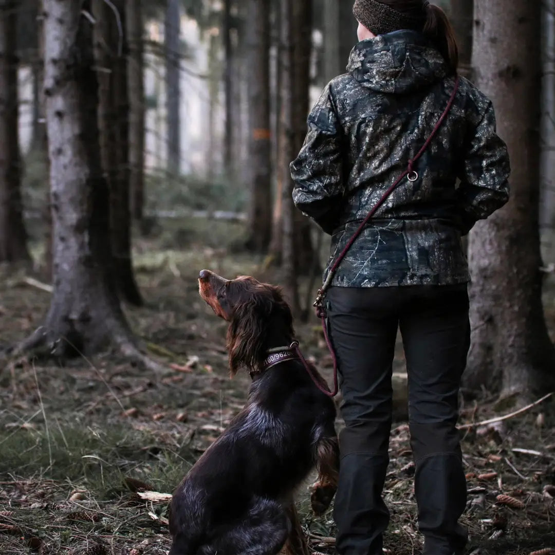 Person in Lady Ann Trousers with a dog enjoying a walk in the forest